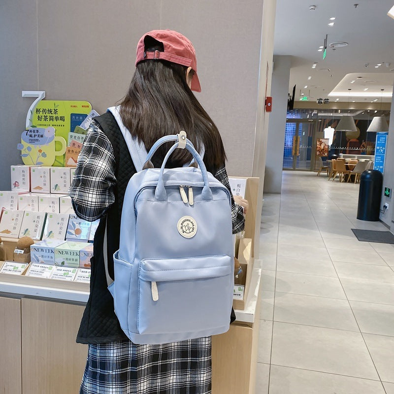 Japanese ins school bag for female middle school students 2023 new simple solid color large capacity backpack female travel backpack